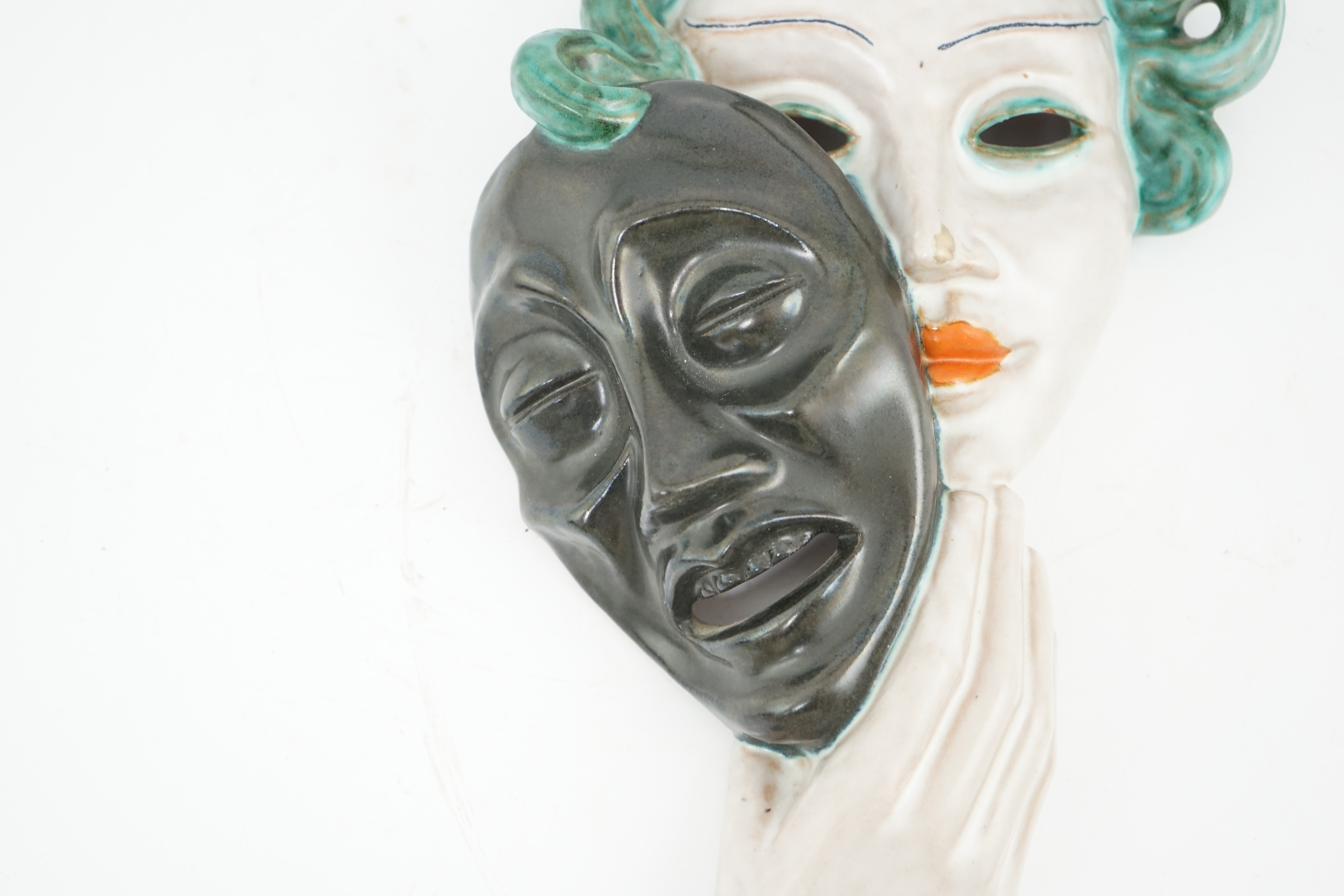 An Art Deco tin-glazed terracotta theatrical wall mask, by Goldscheider